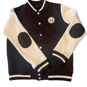 Boys varsity style jacket in navy and off white with patchwork detailing.